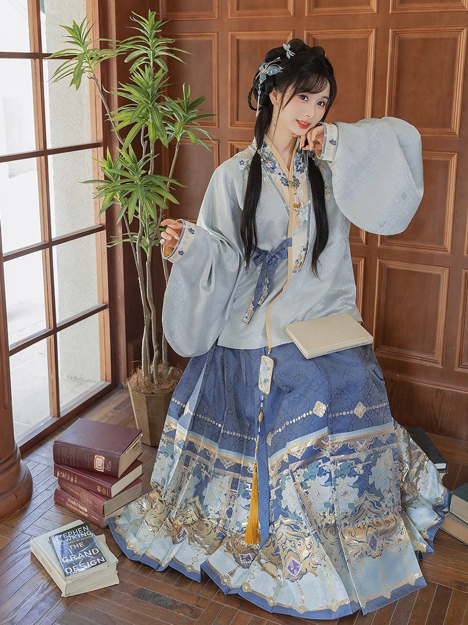 Side three-quarter view of a Ming Dynasty Hanfu costume showing wide sleeves, structured mamian skirt pleats, and detailed gold floral embroidery