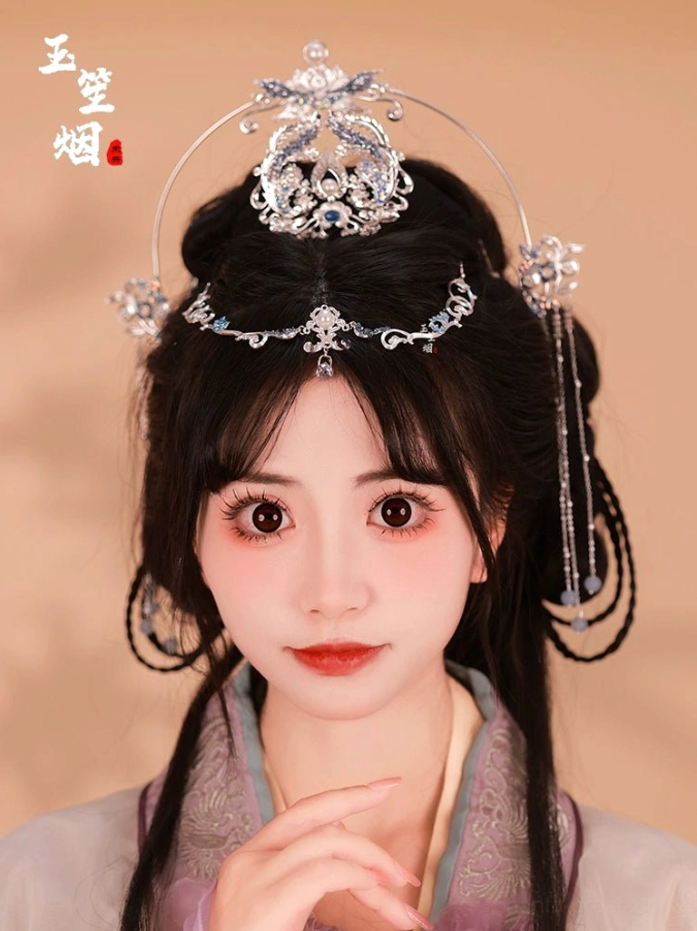 Complete silver blue phoenix lotus Hanfu hair accessories set worn by a model with traditional Chinese hairstyle, featuring halo headpiece crown forehead chain faux pearls and tassels