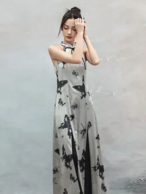 Upper-body view of a silver butterfly print cheongsam dress showing the smooth satin-like fabric, halter neckline, fitted silhouette, and contrasting black inner slit lining
