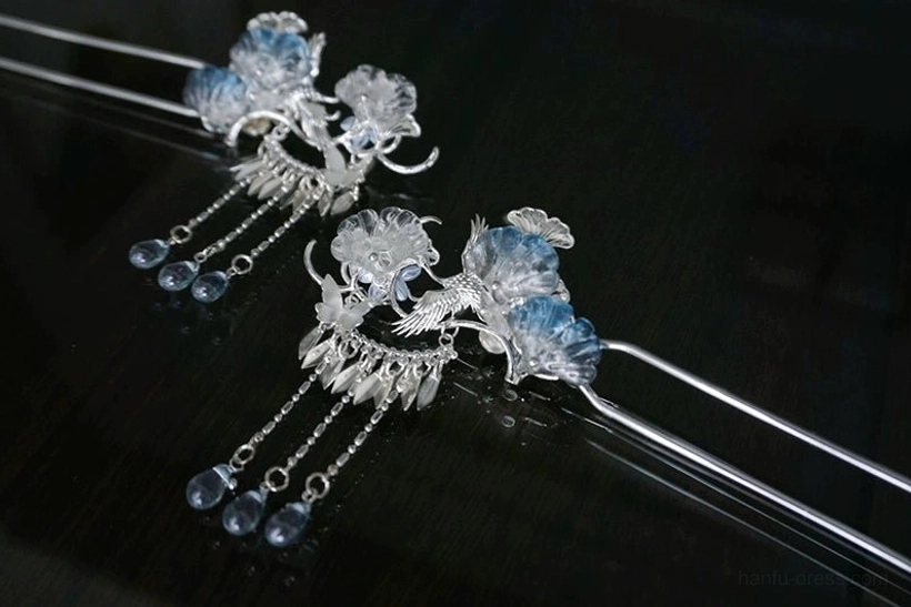 Silver Frost classical Chinese hanfu hairpin pair with silver-tone floral and bird details, blue flower ornaments, butterfly accents, and teardrop tassels