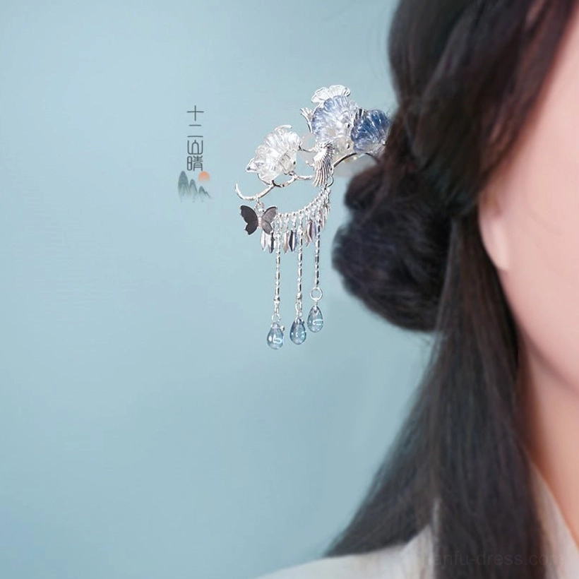 Silver Frost blue flower tassel Chinese hanfu hairpin worn in a traditional dark hair updo, featuring silver-tone metal, butterfly accent, and blue teardrop pendants