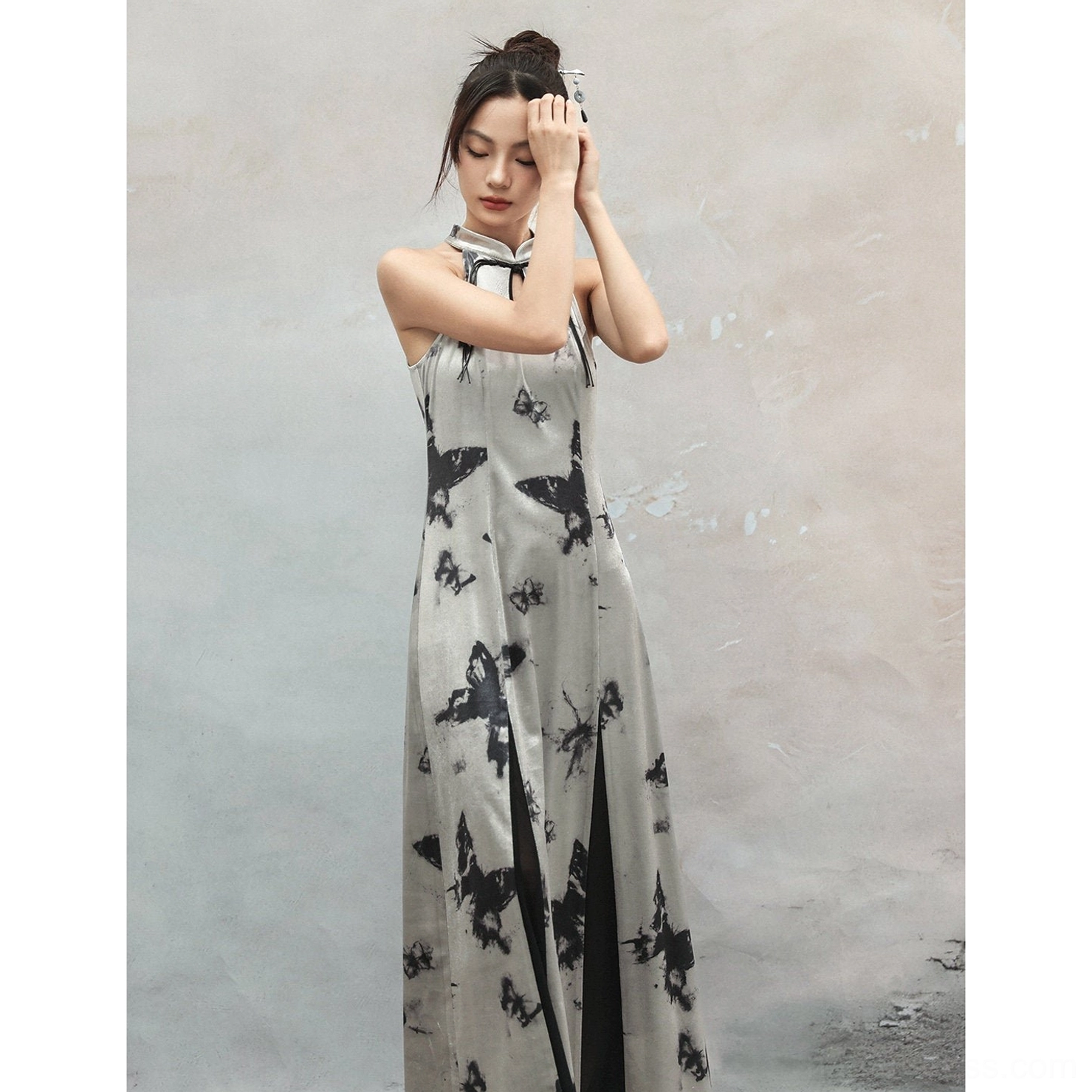 Three-quarter side front view of a silver halter butterfly print modern Hanfu dress with tie closure, high side slit, glossy fabric, and full ink-style pattern