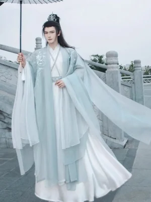 Full body front view of men's Wei Jin dynasty inspired cyan and white hanfu set with oversized sleeves and oil paper umbrella
