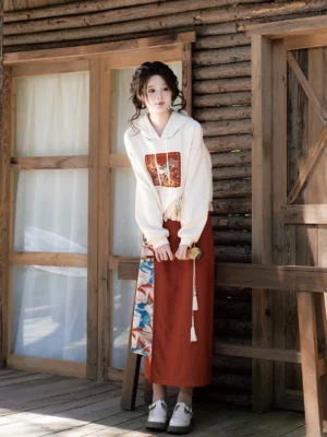 Singing Deer Chinese-inspired modern Hanfu outfit featuring an embroidered cropped hoodie and terracotta wrap skirt styled with leather loafers