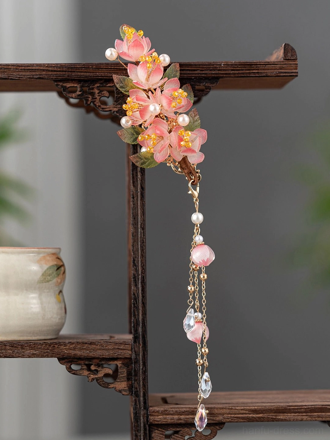 Single pink cherry blossom Hanfu side hair clip with hanging gold-tone tassel chain, pearl accents, pink beads, and teardrop crystal charm