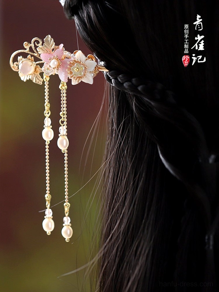 Single floral Hanfu hair stick worn in braided black hair with gold filigree pink flowers and dangling pearl chains