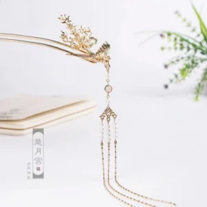 Single golden phoenix hairpin shown from a three-quarter angle with intricate foliage carving layered tassels and a round decorative bead