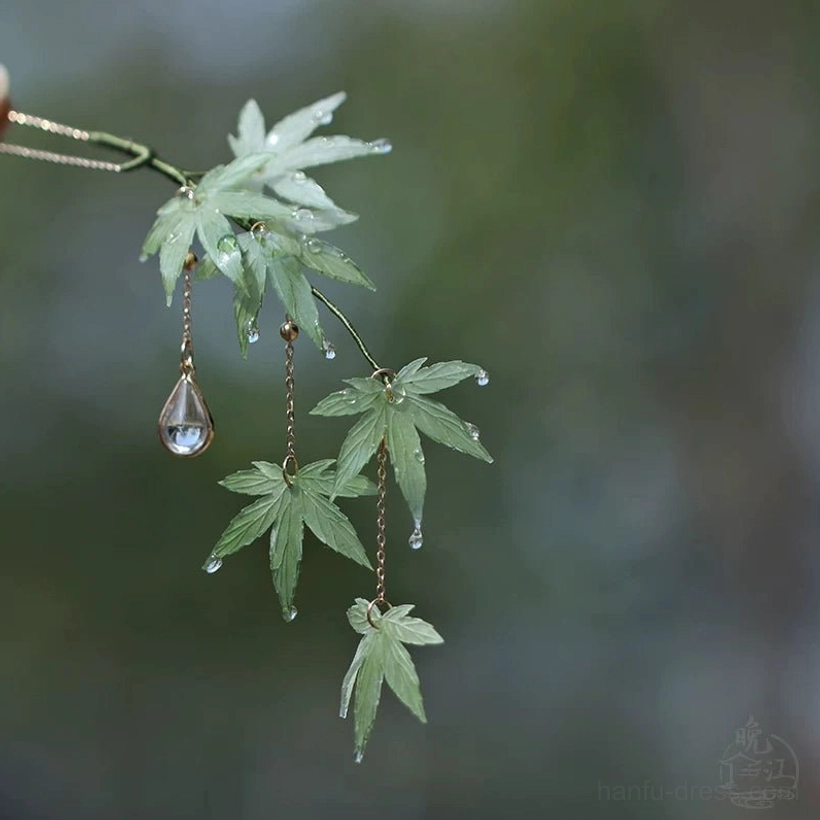 Side view of a single-sided mint maple leaf Hanfu hair stick with gold chains, crystal teardrop, leaf charms and decorative tassels