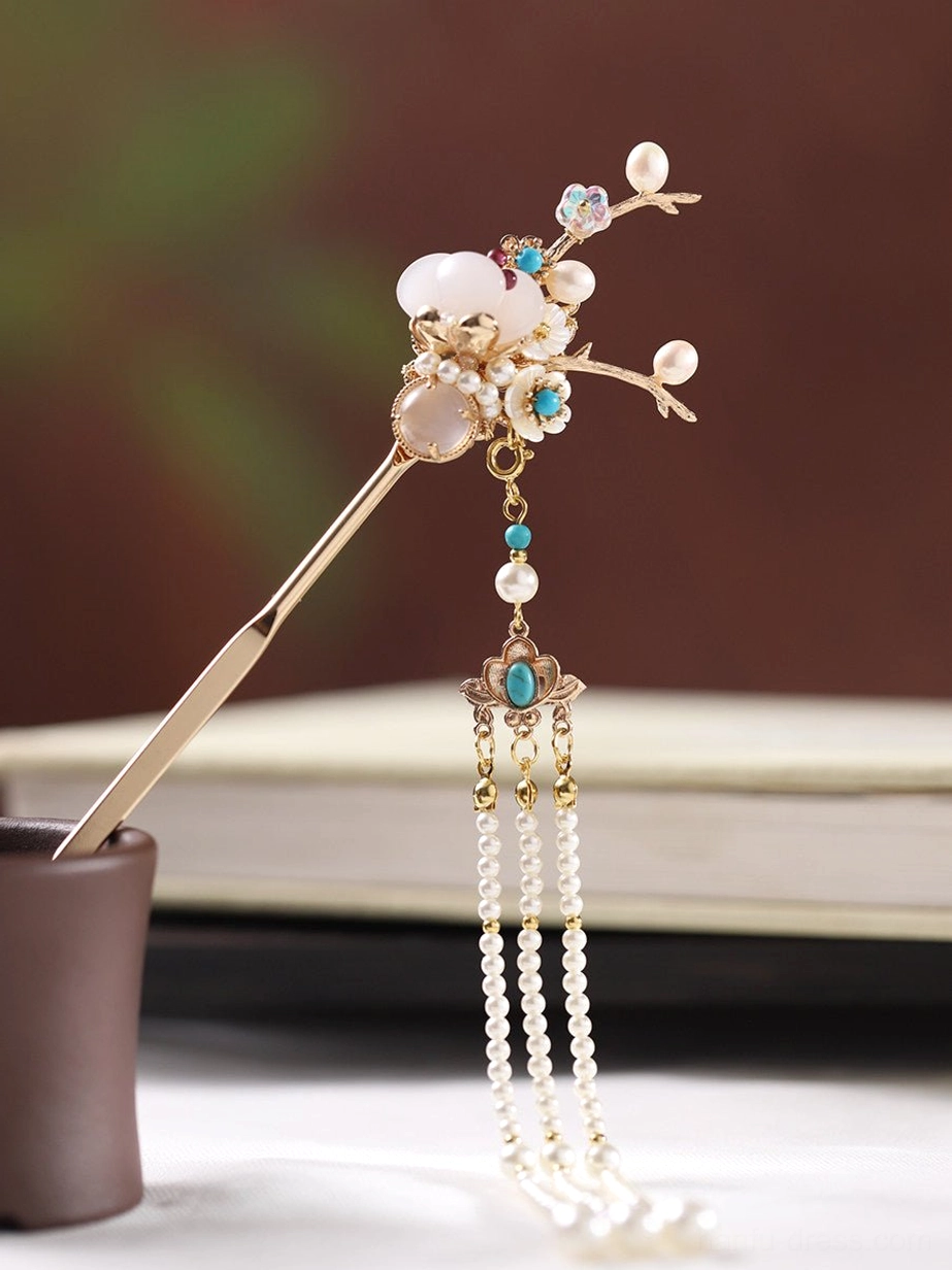Single traditional Chinese hair stick with a long golden shaft, flower branch ornament, milky white beads, blue accents, and an elegant pearl tassel