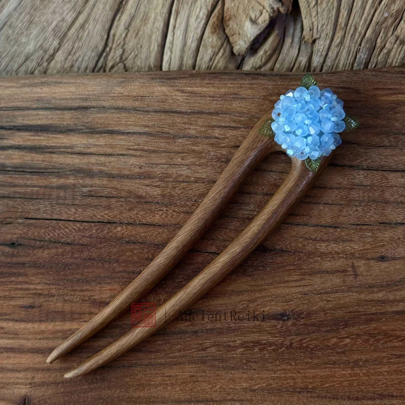 Handmade sky blue hydrangea-inspired Chinese hair stick with opalescent floral beads and green metal accents for Hanfu, qipao, cheongsam, and traditional Chinese hairstyles