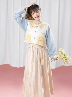 Sky blue modern Hanfu Ming-inspired three-piece set with embroidered ivory vest and beige pleated skirt front view