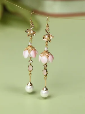 Front view of pink flower Hanfu dangle earrings with intricate gold floral tops, delicate chain details and round pearl drops