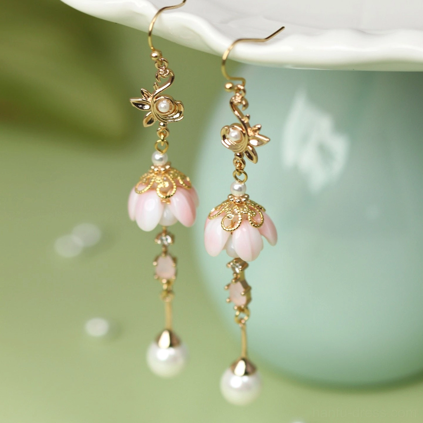 Hook earrings with pink bell flower pendants, gold floral ear wires, sparkling chain accents and round pearl drop charms