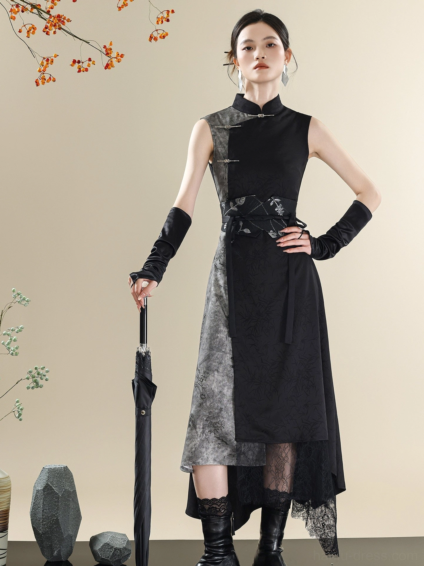 Full-body front view of a sleeveless modern Chinese dress with Mandarin collar, monochrome ink-wash fabric, asymmetric hem, and traditional embroidered waist cincher