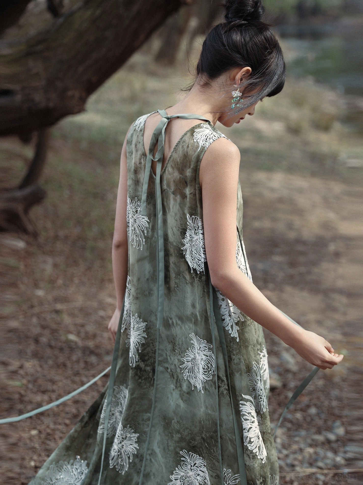 Back full-body view of a sleeveless modern Hanfu floral maxi dress with adjustable sash, relaxed fit, and flowing floor-length hem