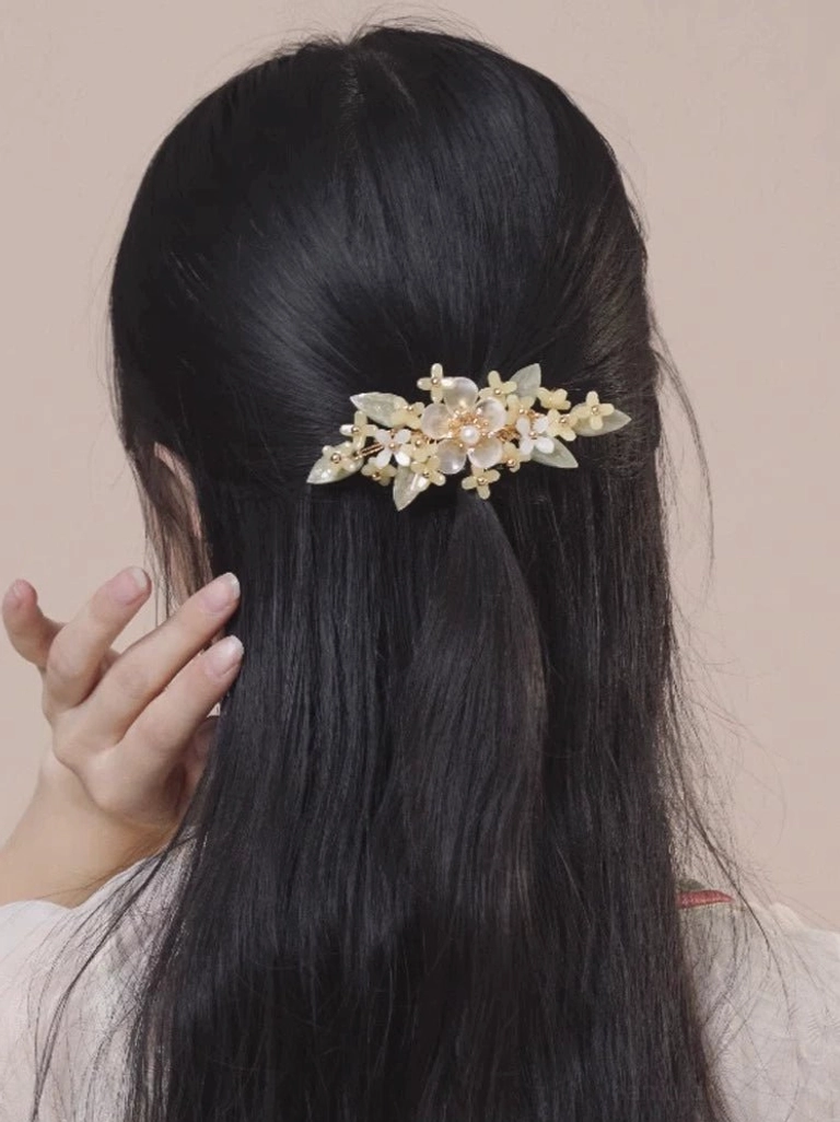 Small floral Hanfu hair clip with cream blossoms and gold-tone hardware styled in a half-up long black hairstyle