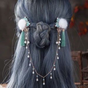 Snow Drops Hanfu back hair pin worn on an ash blue braided hairstyle with white pom pom ornaments, cyan tassels, turquoise leaf details and pearl teardrop chains