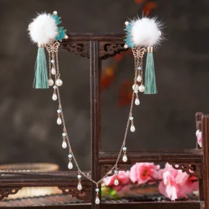 Snow Drops traditional Chinese Hanfu back hair pin displayed on a wooden rack with antique bronze tone clips, white pom poms, cyan tassels and pearl teardrop pendants
