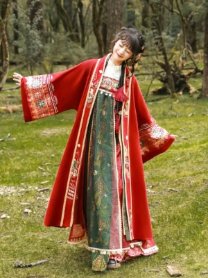 Front view of Dunhuang inspired Tang Dynasty Hanfu festive separates with wide sleeve red embroidered outer coat in a meadow