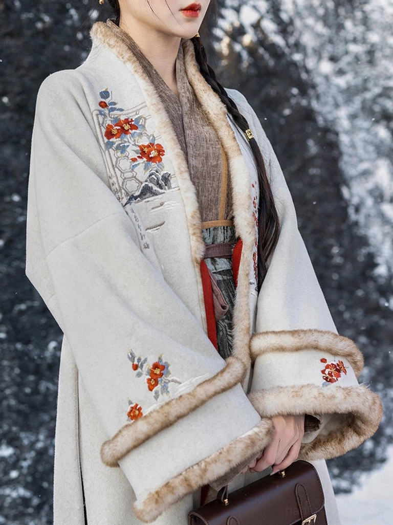 Close up of apricot Song Dynasty hanfu velvet jacket with beige faux fur trim floral embroidery and layered styling