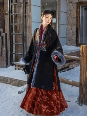 Black Song Dynasty modern hanfu velvet jacket with grey faux fur trim and red bamboo wrap skirt in snowy courtyard