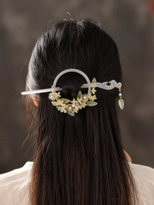 Snow lotus Chinese back hair pin worn on long black hair with milky white imitation jade clasp yellow flower beads green leaves and leaf pendant
