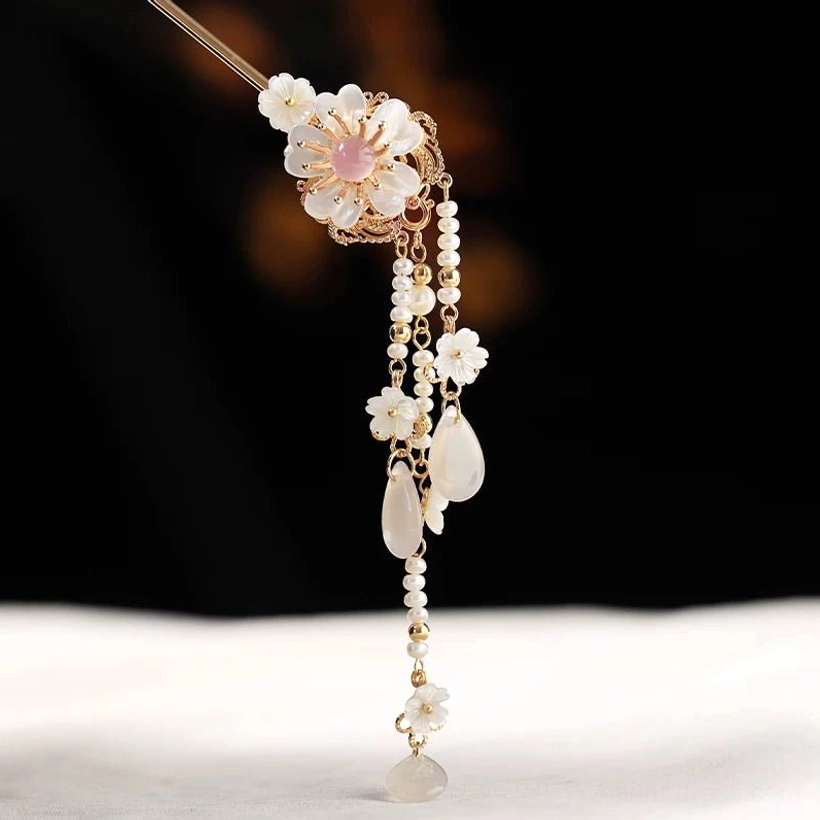 Snow Lyrics traditional Chinese hair stick full view featuring a white flower, pink center, bead tassels, and agate pendants