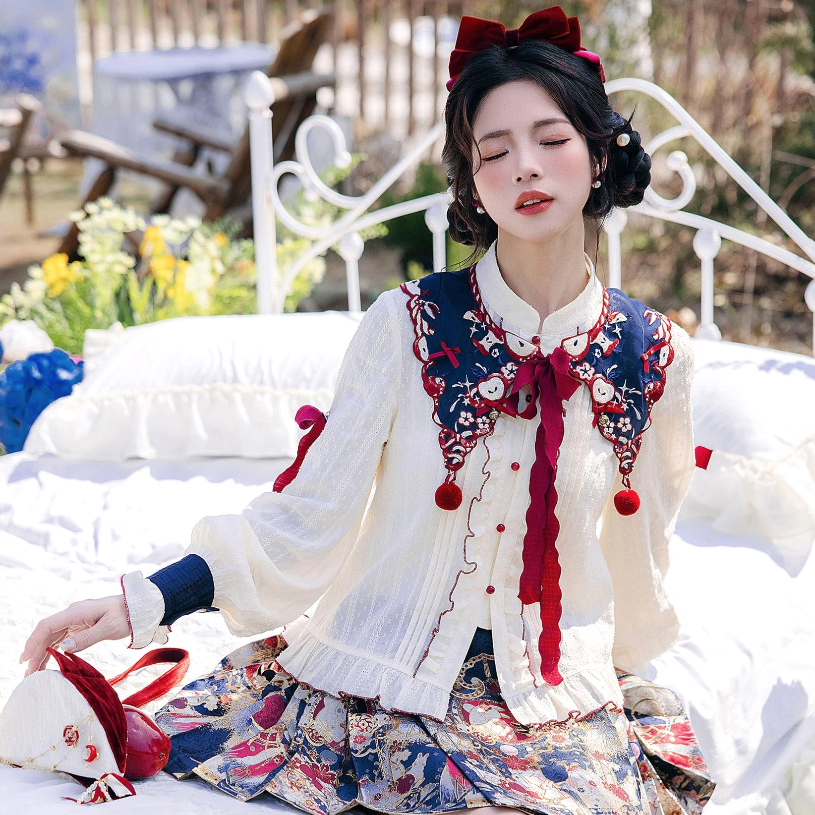 Snow White inspired cream modern Hanfu blouse with embroidered cloud collar, red button placket, and apple themed pompom details
