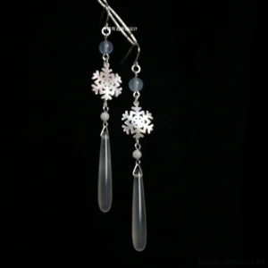 Snowflake drop Chinese earrings for Hanfu with silver hooks, icy blue beads and long transparent teardrop pendants on black background