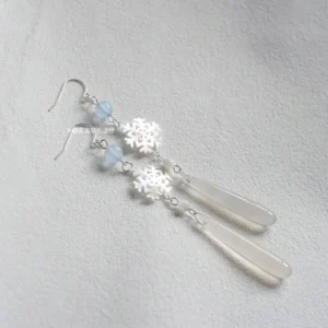 Iridescent snowflake Hanfu drop earrings with light blue beads, frosted water-drop pendants and silver tone ear hardware on grey fabric