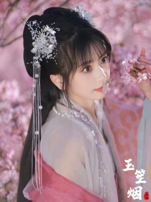 Single Snowy Hanfu hairpin with delicate crystal flower ornament, long silver chain tassels, and rounded bead pendants shown with traditional Chinese hairstyle