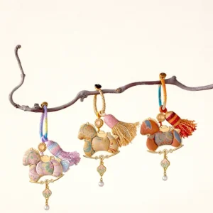 Three Song brocade rocking horse Chinese keychain bag charms in lavender pink, khaki and reddish brown with colorful woven cords, tassels and pearl-drop pendants