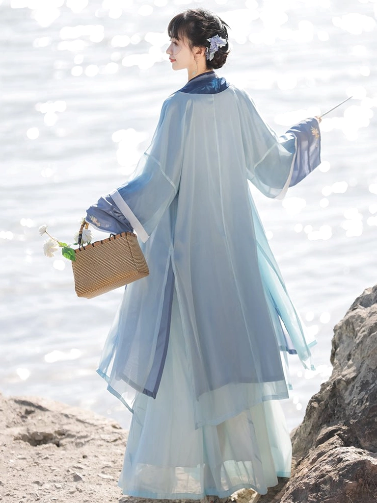 Back view of a Song Dynasty style blue Qiyao Ruqun Hanfu showing the flowing light blue beizi coat, dark blue collar trim, gradient pleated skirt, and woven flower handbag