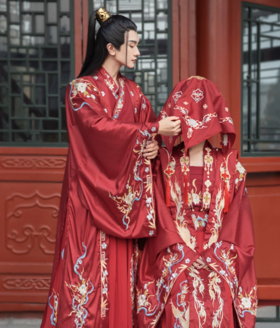 Song Dynasty inspired Chinese wedding hanfu couple wearing matching crimson phoenix and cloud embroidered outfits