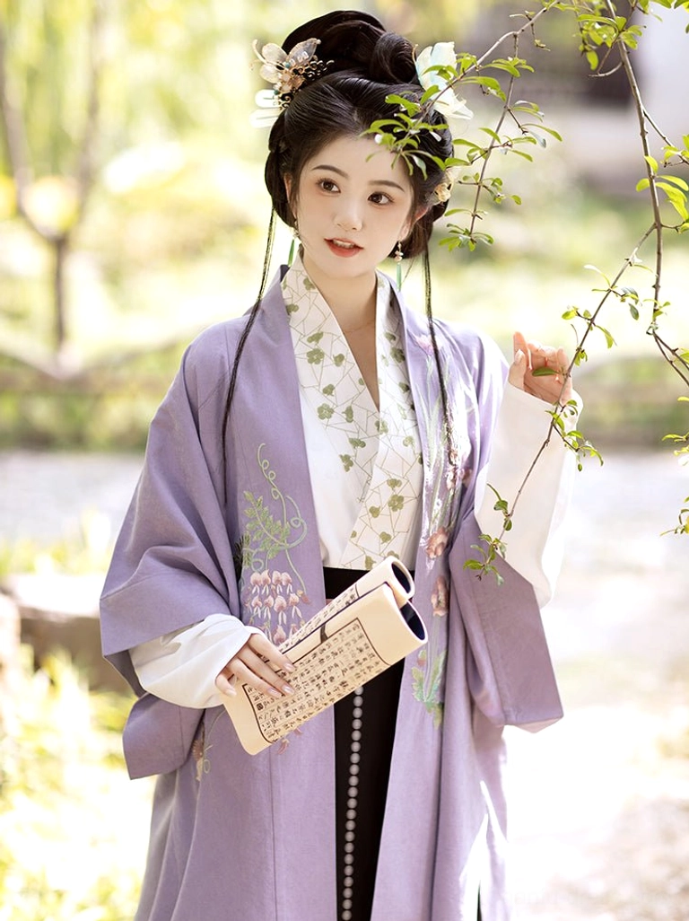 Close view of Song Dynasty Hanfu outer robe and white cross-collar inner top with floral details worn in a traditional garden