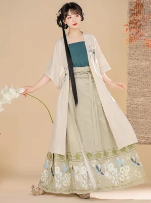 Front view of a Song Dynasty Hanfu three-piece outfit with ivory beizi coat, teal camisole, khaki embroidered mamian-style skirt, traditional hairstyle, and white orchid flower