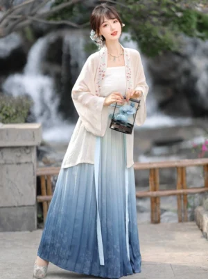Front view of elegant Song Dynasty Hanfu with cream outer coat and blue gradient pleated skirt styled with a vintage black handheld lantern in a classical courtyard