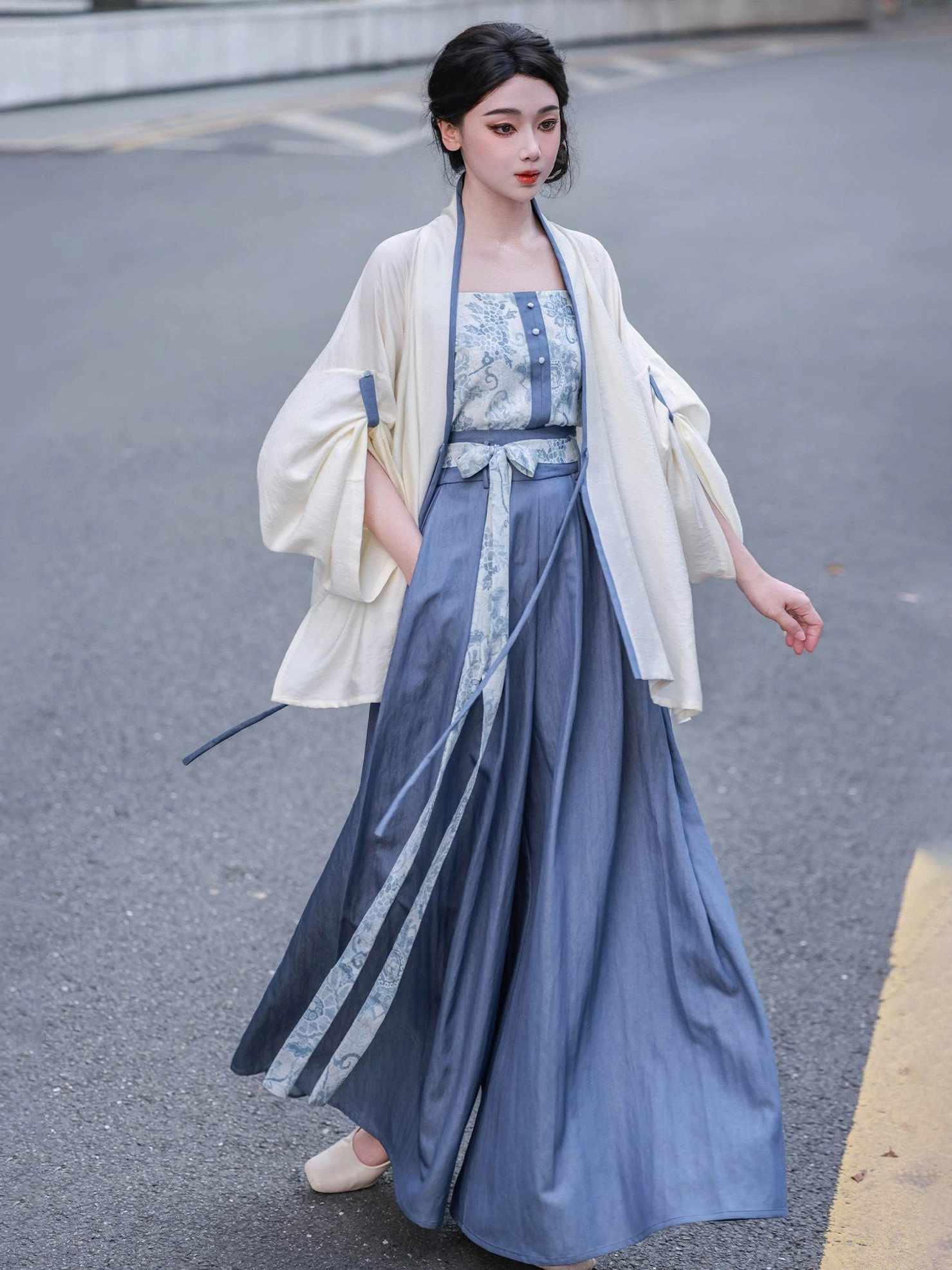Song Dynasty inspired Hanfu camisole and ivory cardigan paired with flowing high-waisted blue wide-leg pants in side view