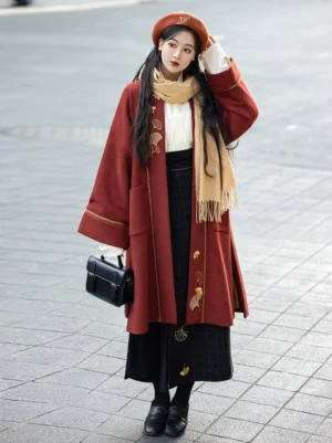Front full-body view of Song Dynasty Hanfu inspired brick red ginkgo embroidered winter jacket with wrap skirt in an urban street setting