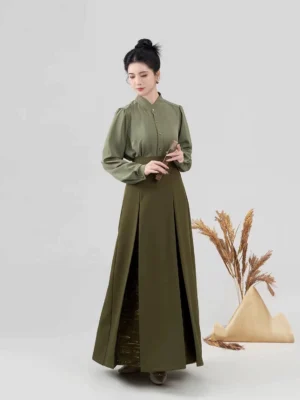 Modern Song Dynasty Hanfu blouse and pleated skirt outfit showing the army green stand-collar top, golden button placket, and high-waisted skirt with side slit