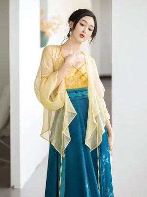Three-quarter close view of modern Song Dynasty Hanfu showing sheer yellow cardigan gold floral halter camisole and teal waist sash