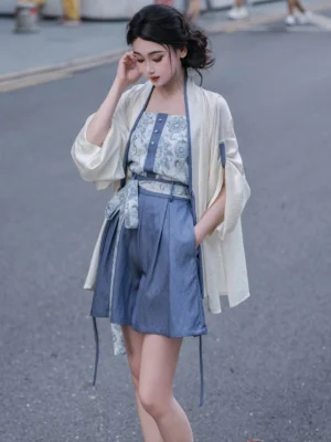 Modern Song Dynasty Hanfu outfit with blue porcelain print camisole, ivory cardigan, high-waisted blue shorts and patterned waist sash