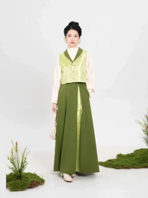 Full-body front view of a modern Song Dynasty hanfu three-piece set with cream lantern-sleeve top, lime green floral jacquard majia vest, and flowing three-pleat skirt