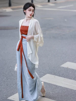 Side view of a modern Song Dynasty Hanfu outfit with flowing cream open front winged sleeve top long waist ribbons and floor length wrap skirt