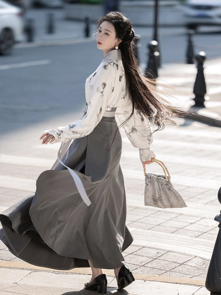 Back view of Song Dynasty inspired Hanfu outfit with flowing ink floral top and dark grey pleated skirt in motion