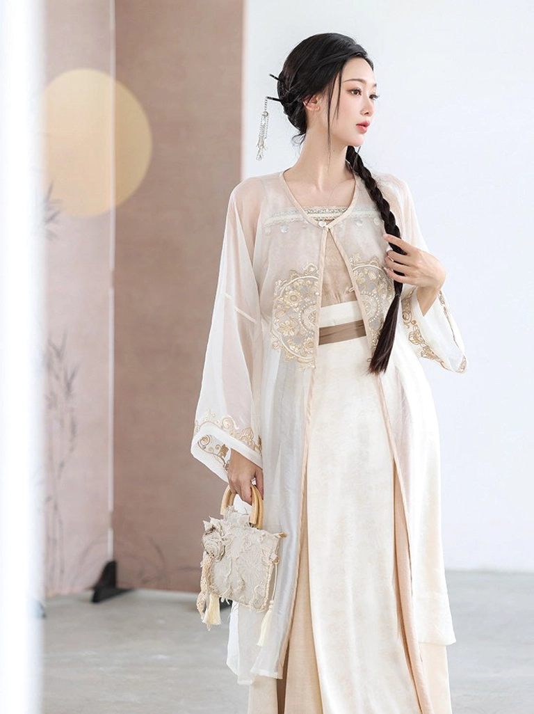 Three-quarter front view of a Song Dynasty-inspired Hanfu set with embroidered sheer cardigan, matching waist belt, pleated skirt, and woven handbag