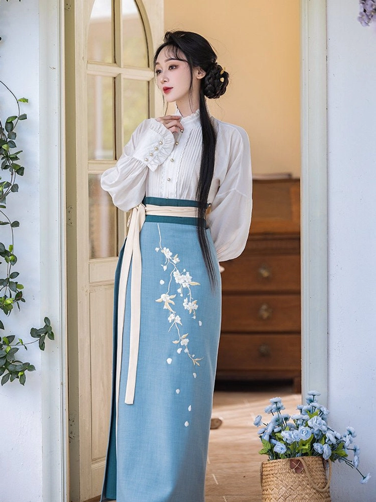 Full front view of a Song Dynasty inspired Hanfu set with beige waist sash, blue embroidered skirt, white blouse, and pear blossom details