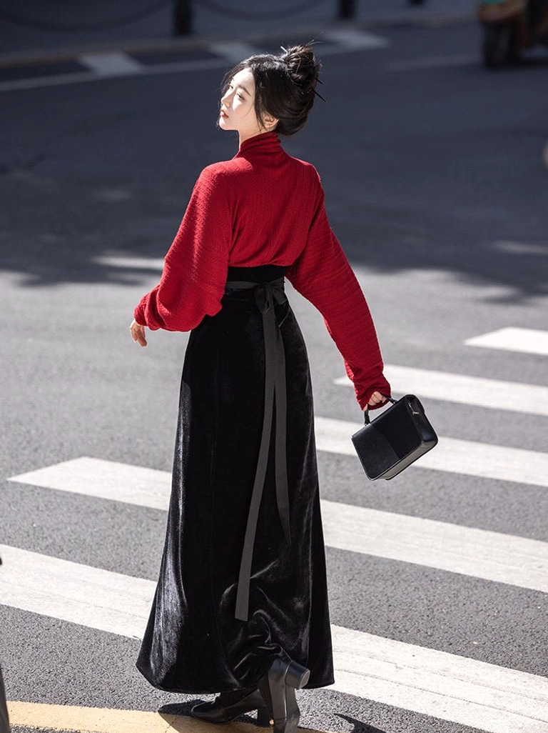 Back view of a Song Dynasty inspired Hanfu set with flowing red wing sleeves, black embroidered skirt, and long waist sash