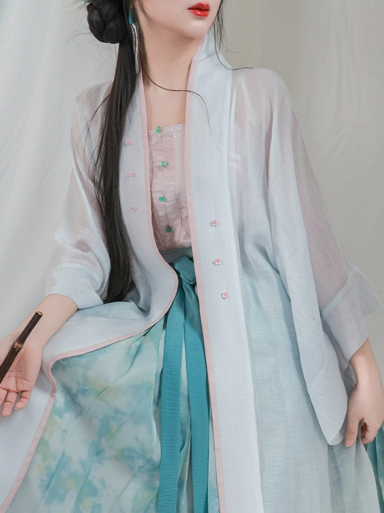 Close up of Song Dynasty lotus hanfu pink jacquard camisole green frog buttons and sheer cardigan front details