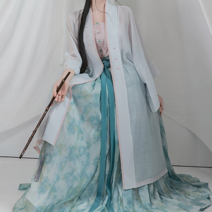 Full front view of Song Dynasty lotus hanfu cardigan camisole and long flowing cyan pleated skirt set
